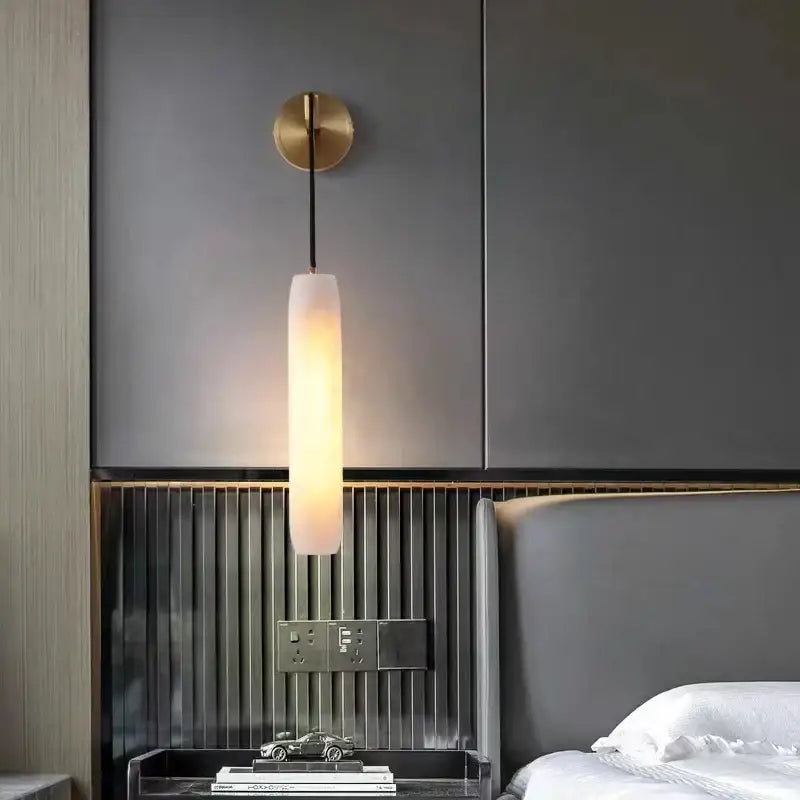 Modern brass and marble wall lamp with decorbites cylindrical frosted glass shade and warm glow for bedroom sconce decor