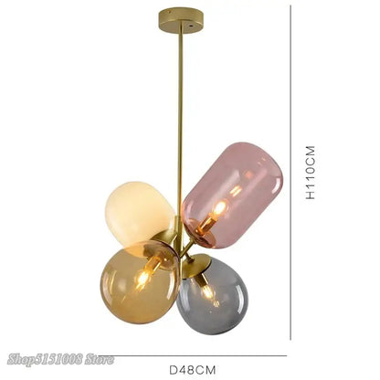 Modern brass and multi color glass pendant light with four soft pink cream amber and gray glass globes for dining room