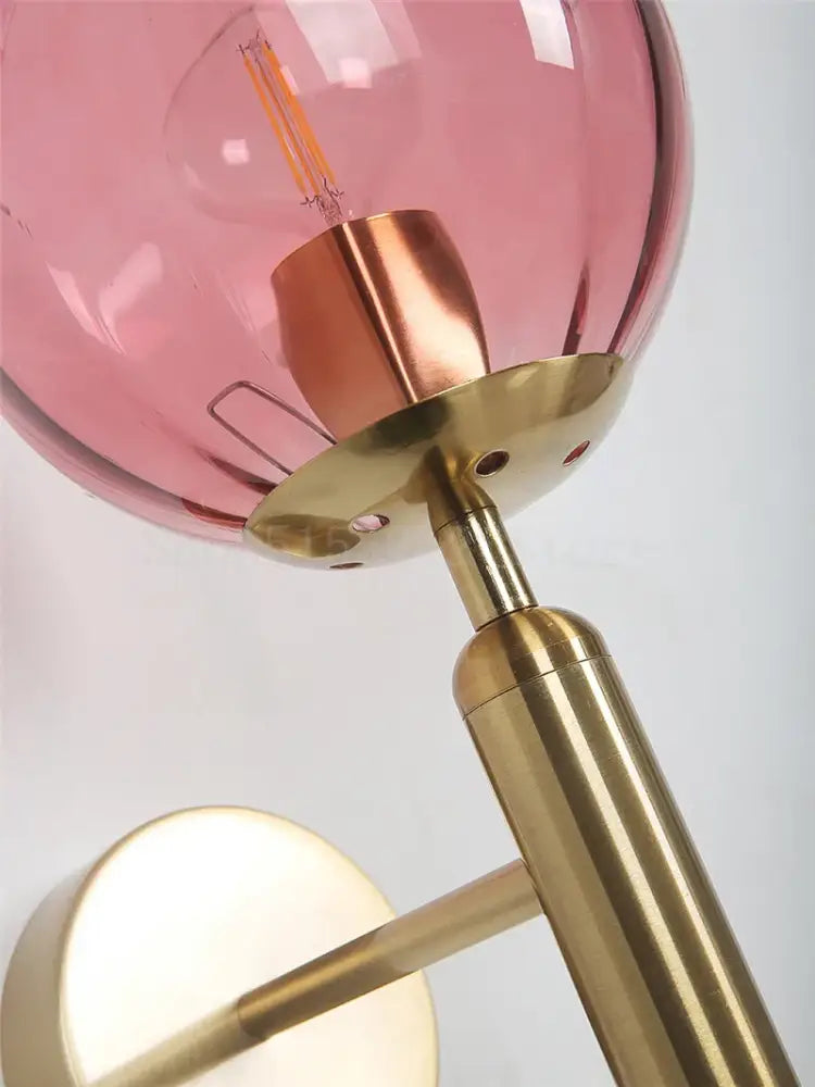 Modern brass and pink glass wall lamp with translucent globe for living room decorbites blue glass style option