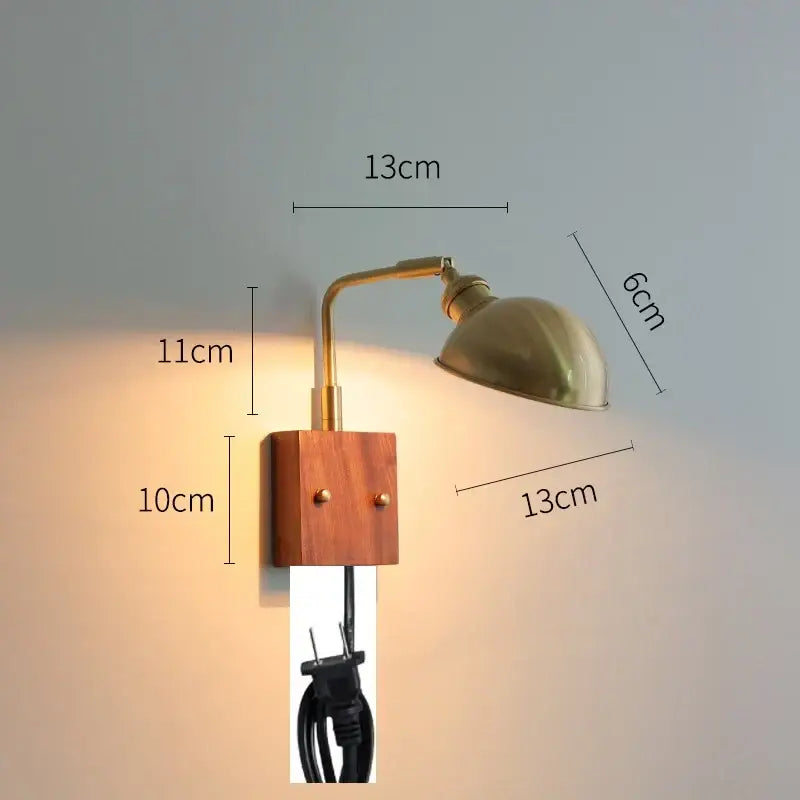 Modern brass wall lights with clear glass and wooden base featuring an adjustable arm for bedroom decorbites clear glass