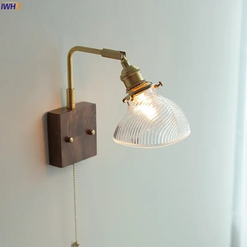 Modern brass wall lights with adjustable ribbed clear glass shade and dark wood mounting plate for bedroom decorbites clear glass
