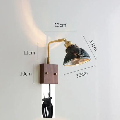 Industrial-style wall lights with brass-finished articulated arm and clear glass shade on dark wood base decorbites clear glass