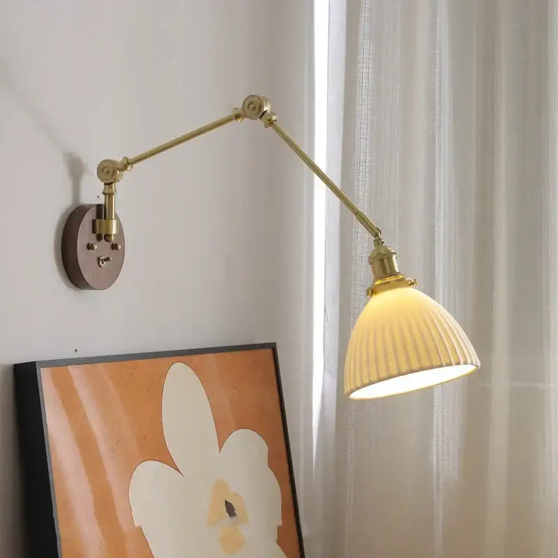 Modern brass and ribbed glass led wall lamp with adjustable arm and cream shade suitable for bedroom wall lamp lighting