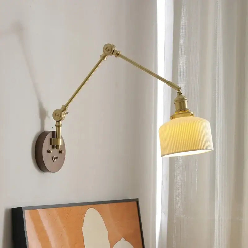 Modern brass led wall lamp with adjustable arm and ribbed cream glass shade for bedroom lighting with pull chain