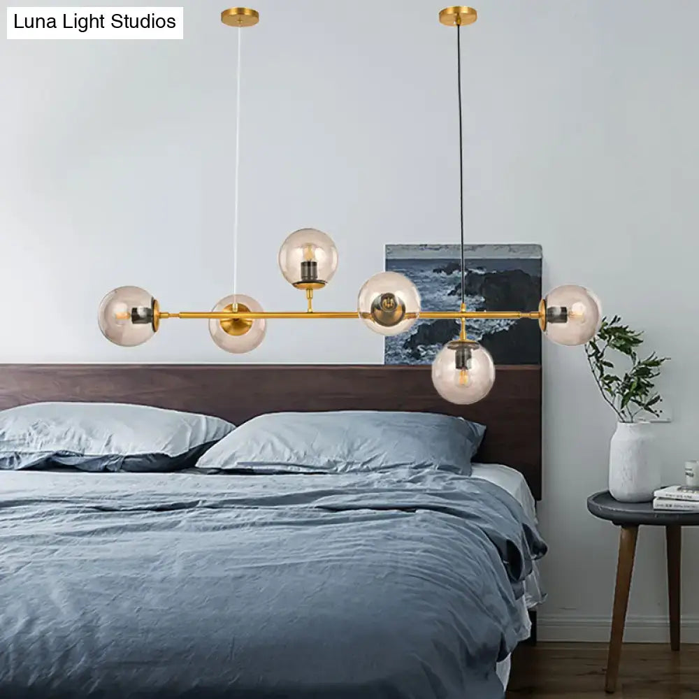 Decorbites™ modern bubble chandelier lighting with six smoke gray glass globe bulbs and gold-toned fixture bar