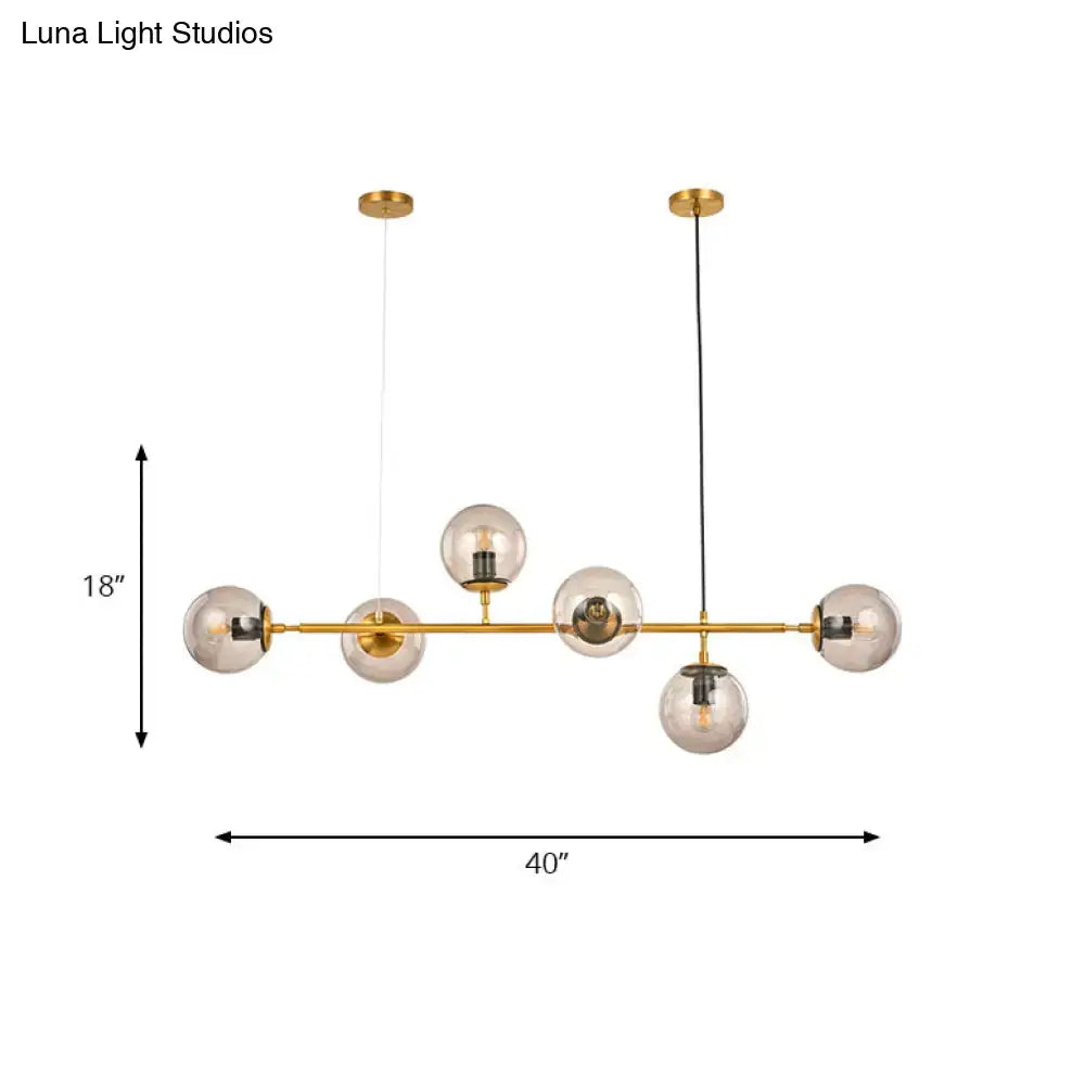 Gold-toned DecorBites™ modern bubble chandelier lighting with six smoke gray glass globe bulbs for kitchen or dining room