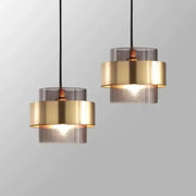 Modern pendant light with stacked brass and smoked glass shades perfect for dining room decorbites gold wrought iron
