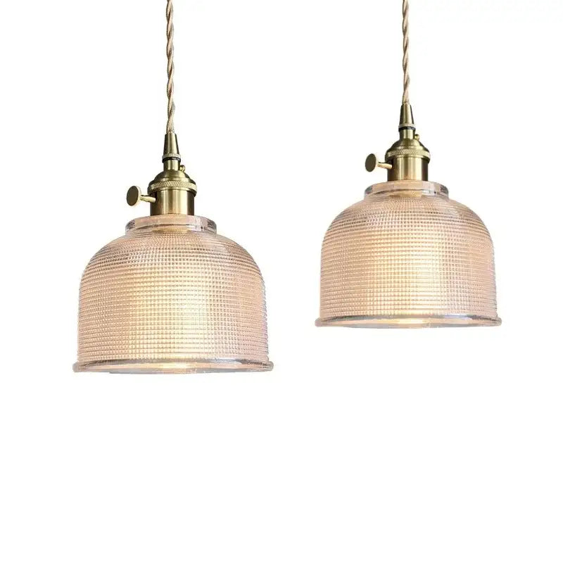Two brass pendant lights with textured clear glass shades and knob switch hanging from twisted cords in kitchen decorbites clear glass