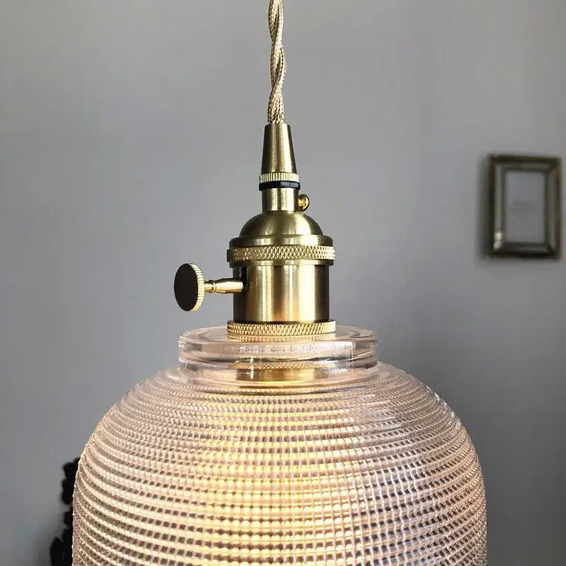 Modern brass pendant light with textured clear glass globe and knob switch for kitchen decorbites clear glass design