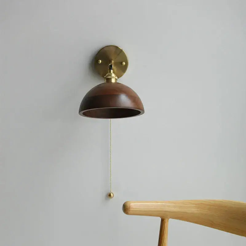 A modern brass and walnut led wall sconce with a dark wood shade perfect for bedroom mirror lighting decorbites led walnut