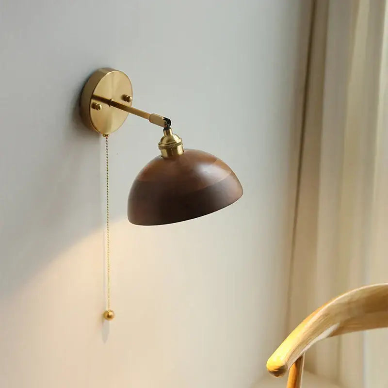 A warm-toned brass wall sconce with led walnut wood dome shade and adjustable arm for bedroom mirror light decorbites led walnut