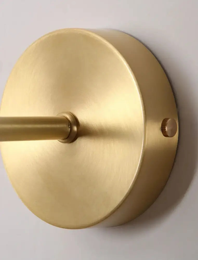 Modern brass and walnut wood wall sconce with a circular minimal design and central rod for bedroom decorbites adjustable walnut