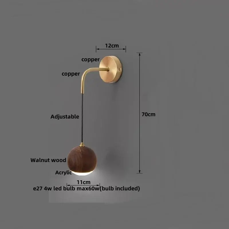 Modern brass and walnut wood wall sconce with copper finish, adjustable arm, and walnut wood sphere diffuser for decorbites