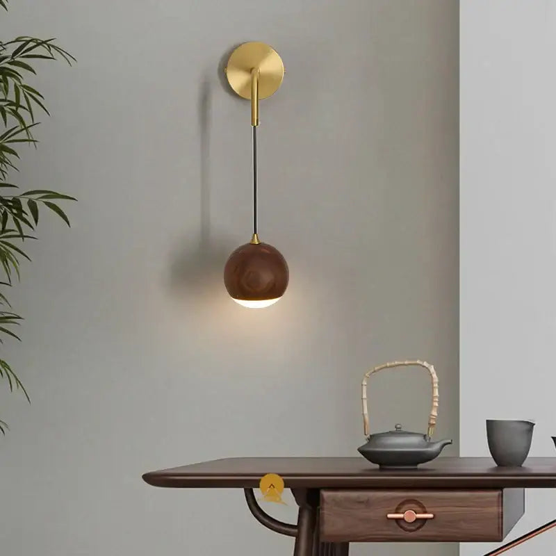 Modern brass and walnut wood wall sconce with gold-toned fixture and spherical wooden lampshade for bedroom decorbites adjustable walnut