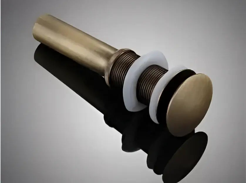 Antique brass basin waste drain stopper with sleek cylindrical design and polished finish for bathroom sinks