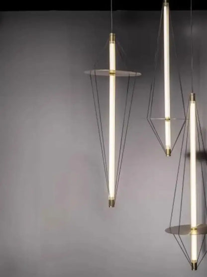 Modern brass and white led disc pendant light with slender glowing tubes suspended by black cords for bedroom decorbites disc pendant
