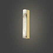 A modern brass and white onyx wall lighting sconce with translucent onyx and polished brass for living room use
