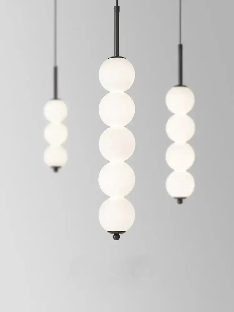 Modern brass and white pearl led pendant lights featuring frosted glass globes on black rods for kitchen decorbites led white
