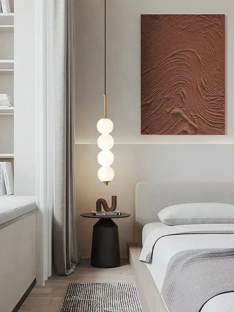 A modern brass pendant light with three spherical led white pearl bulbs for kitchen decorbites led white hanging lamp