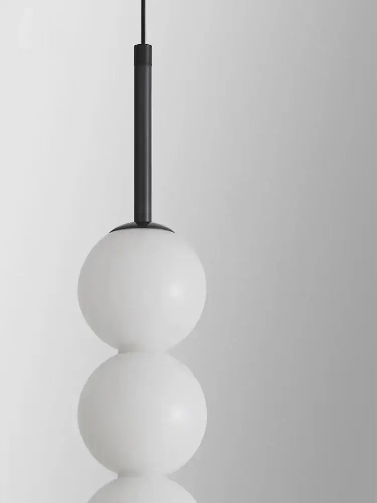 Modern brass and white pearl led pendant lights with three stacked opaque glass spheres from decorbites led white collection