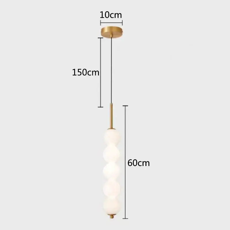 Modern brass and white pearl led pendant lights feature five frosted glass spheres on a 60cm brass stem decorbites led white