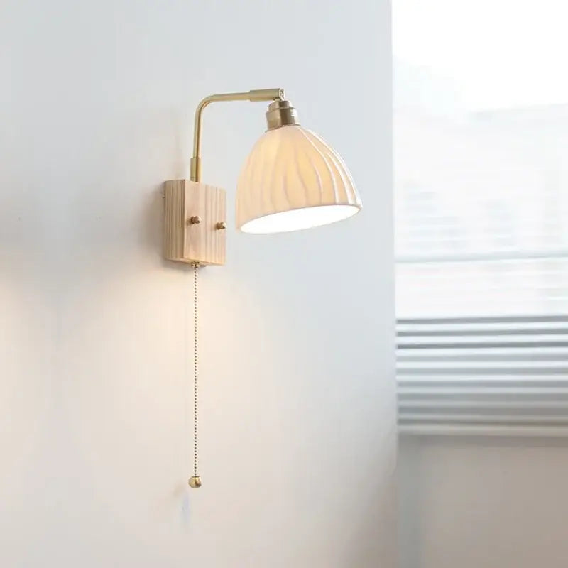Modern brass and wood ceramic led wall sconce with off-white ribbed ceramic shade for bedroom vanity decorbites ceramic led