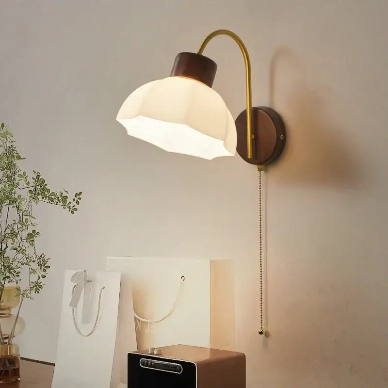 Modern brass and wood led wall sconce pull chain with warm-toned brass and white petal-shaped glass shade for bedroom decorbites led wall