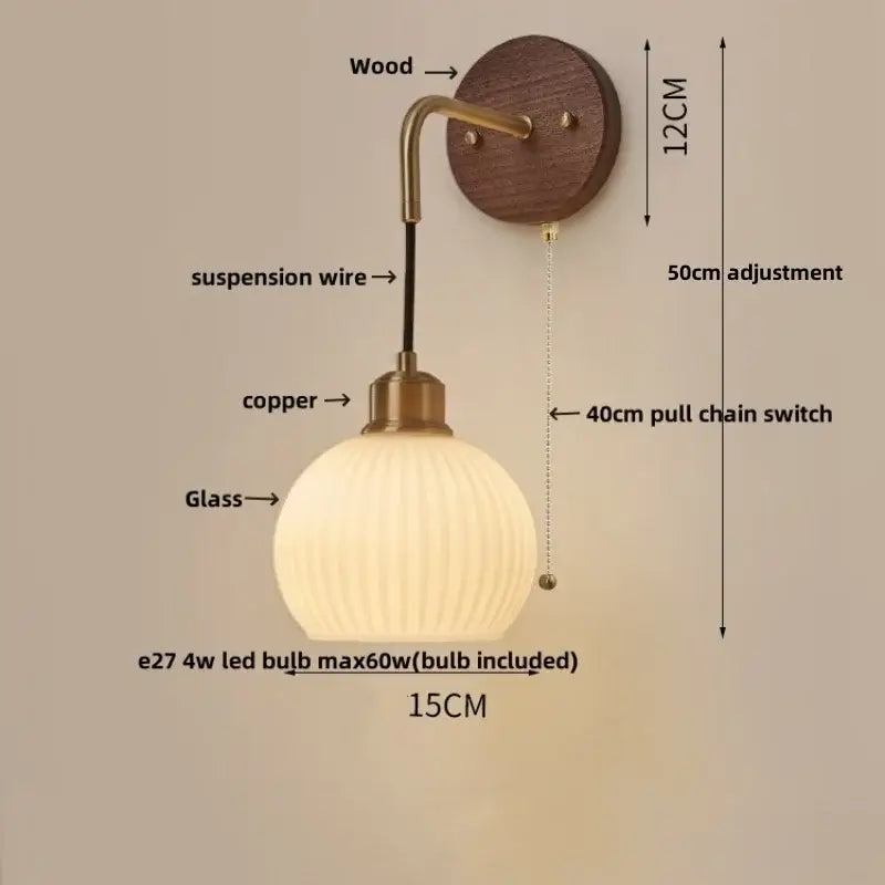 Modern brass and wood ribbed glass wall light with warm-toned globe on copper adjustable led arm for bedroom decorbites