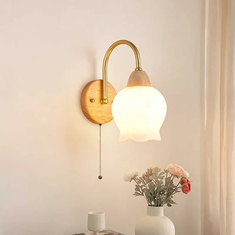 Modern brass and wood tulip led wall lamps with a brass arm wooden backplate and frosted glass shade for decorbites led wall lamps