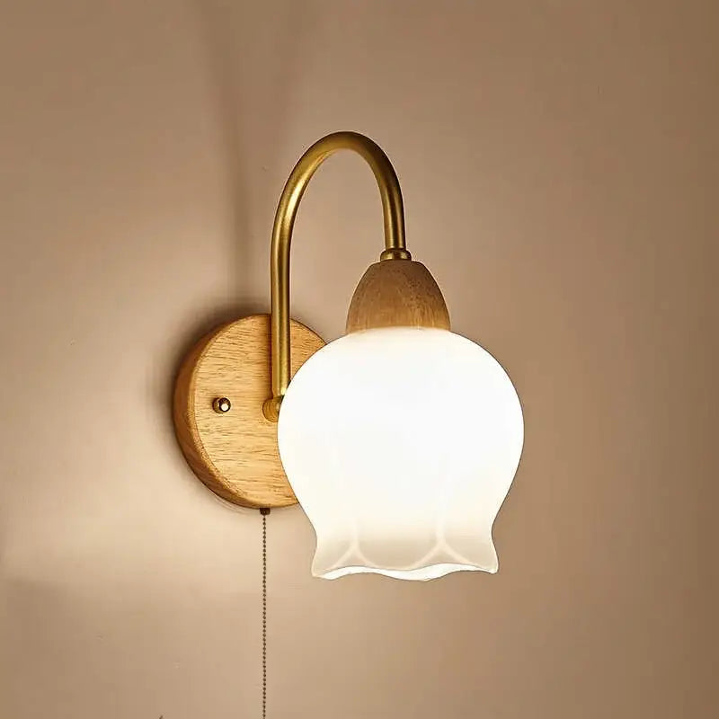 A warm-toned modern brass and wood tulip led wall lamp with frosted white glass shade for living room decorbites led wall lamps