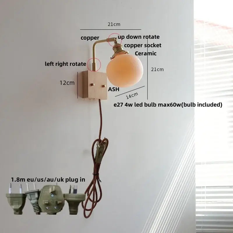 Modern copper-finished wall light fixture with ceramic globe shade and adjustable arm for bedroom lighting