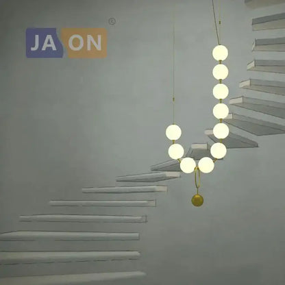 Modern brass artistic necklace chandelier pendant light with glowing white bulbs and golden accent sphere for living room decorbites brass artistic