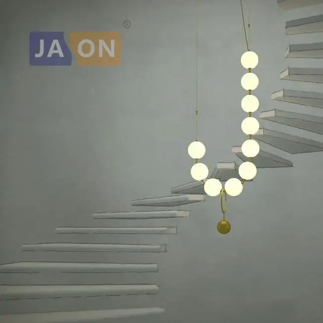 Modern brass artistic necklace chandelier pendant light with glowing white bulbs and golden accent sphere for living room decorbites brass artistic