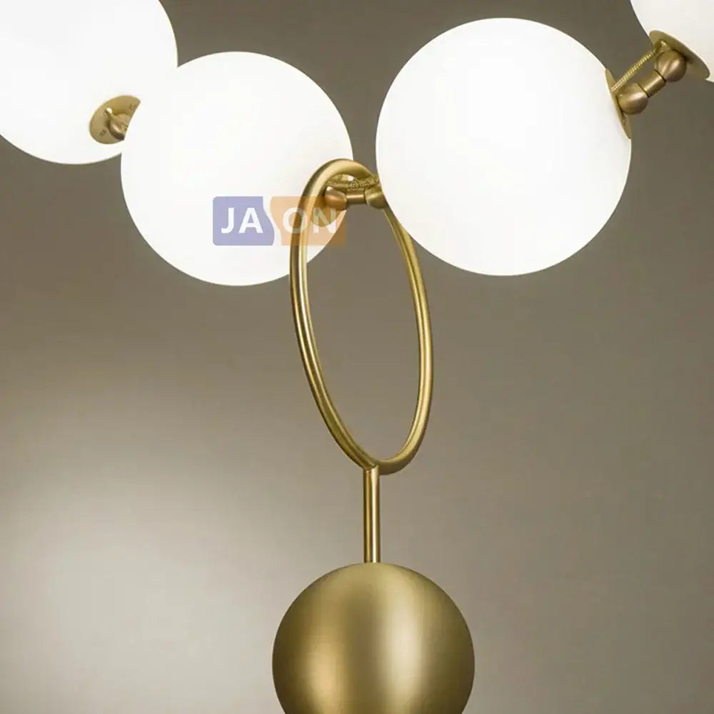 Modern brass artistic necklace chandelier pendant light with gold-toned spheres frosted glass and polished brass ring accent