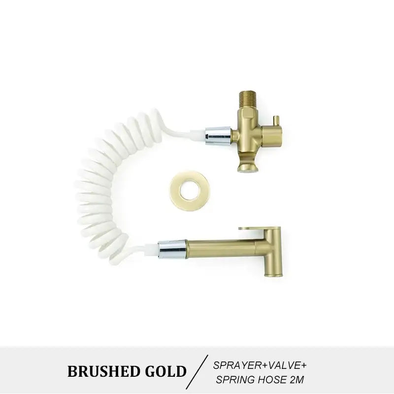 Modern brass bidet spray kit with brushed gold bidet spray and coiled white spring hose and matching valve assembly
