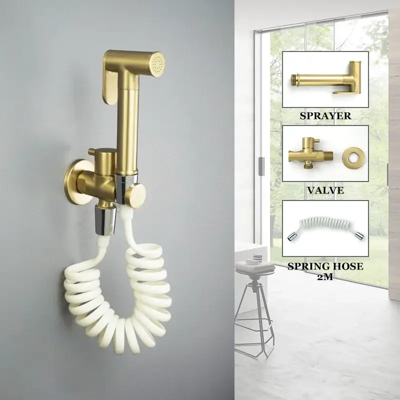 Modern brass bidet spray kit with gold-colored wall-mounted sprayer and coiled white hose for bathroom use