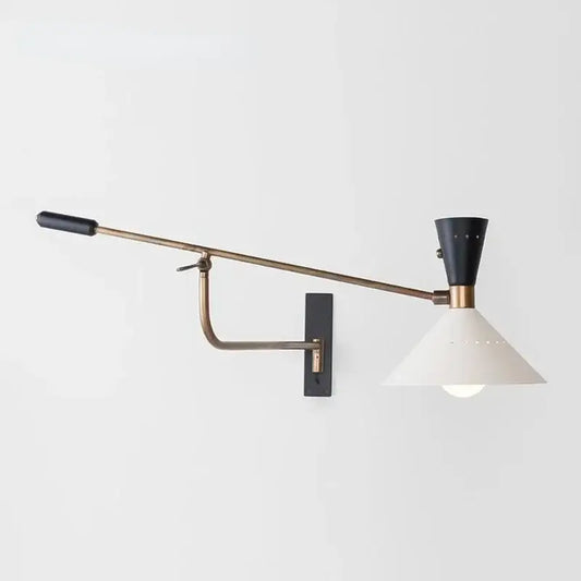 A sleek brass and black decorbites adjustable metal bedroom sconce light with a wall-mounted adjustable arm
