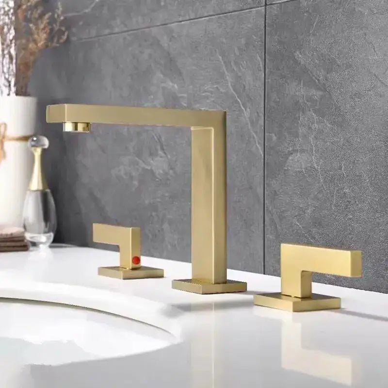 Modern gold-toned brass black basin faucet with sleek angular design and two matching handles for bathroom sink decorbites brass black basin
