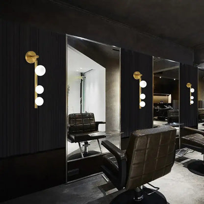 Modern brass and black frosted glass wall lamp with chrome base paired with black leather tufted barber chair decorbites elegant mirror headlight