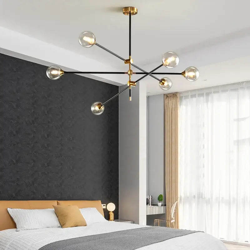 Modern brass and black geometric glass ball chandelier featuring clear glass globe bulbs for dining room decorbites geometric glass lighting