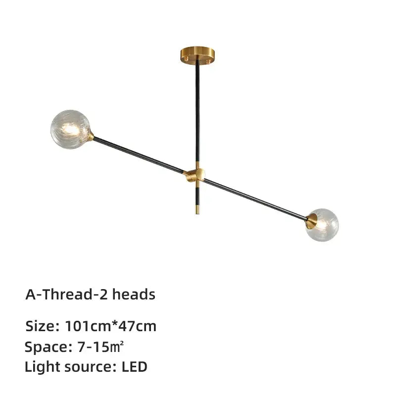 Modern brass and black geometric glass ball chandelier with two-arm pendant light featuring clear glass globe bulbs for dining room decorbites geometric glass
