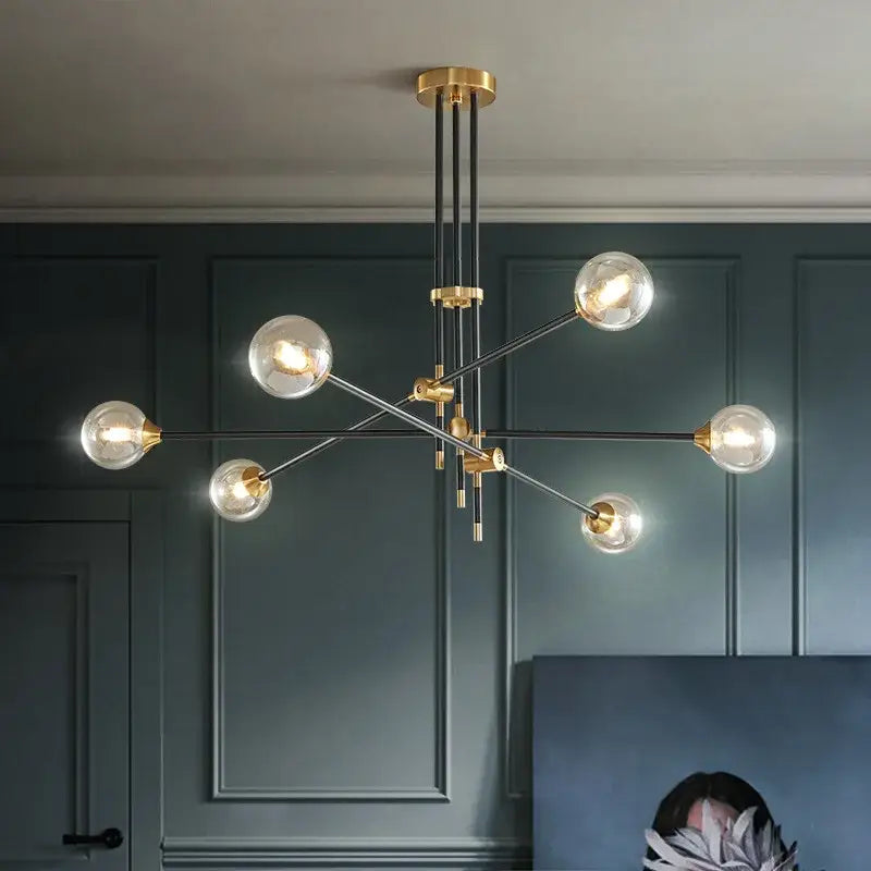 Modern brass and black metal geometric glass ball chandelier with clear glass globe bulbs for dining room decorbites geometric glass