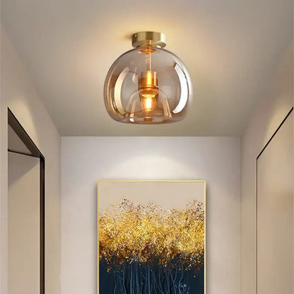 Modern brass and black glass ball LED ceiling light featuring a smoked glass globe and gold-toned metal accents decorbites glass ball