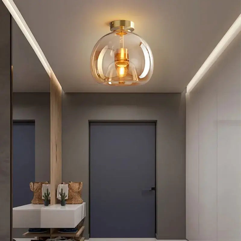 Modern brass and black glass ball led ceiling light with glass globe and warm ambient glow for living room decorbites ceiling light