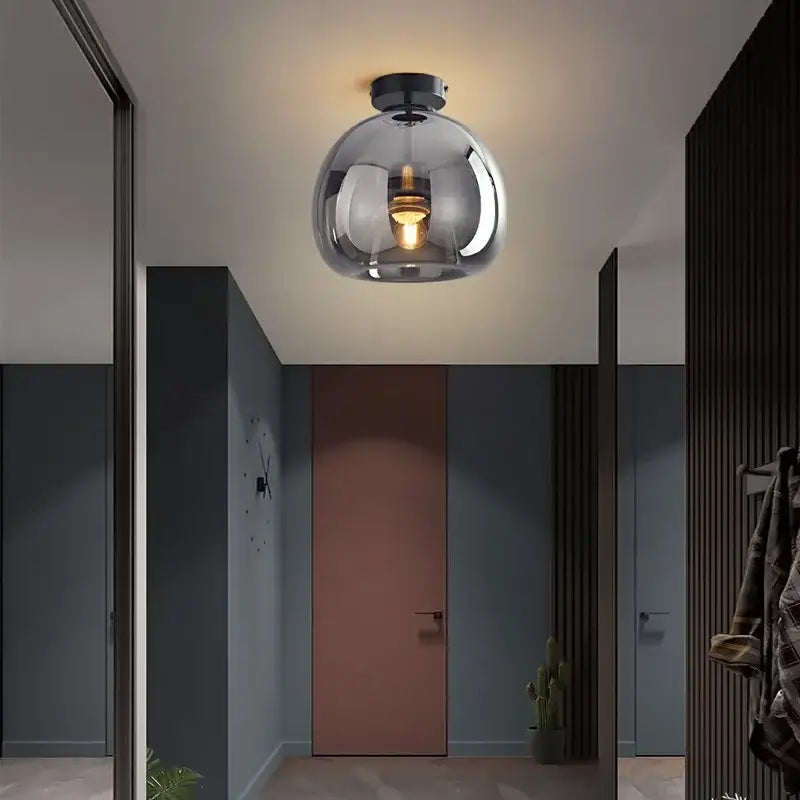 Modern brass and black decorbites glass ball led ceiling light with spherical metallic glass and exposed bulb for living room decor