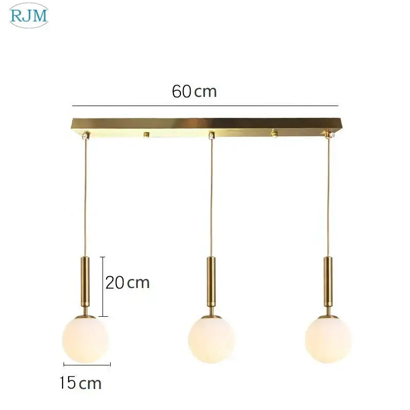 Modern brass pendant light with three gold-toned decorbites glass ball led frosted shades for dining room decor