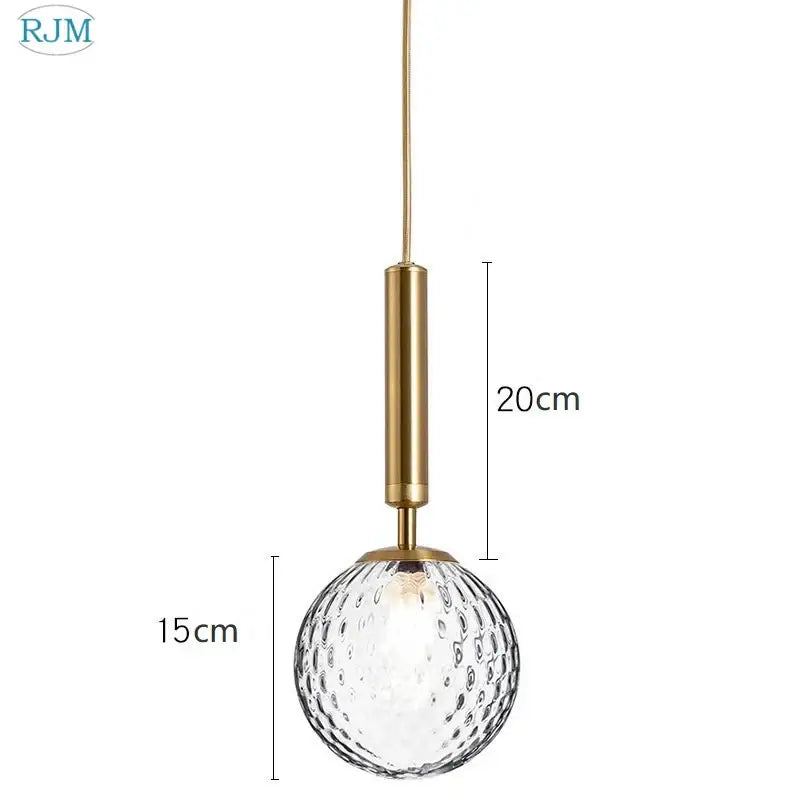 Modern brass and black glass ball led pendant light with gold-toned metal stem and textured clear glass globe decorbites pendant light