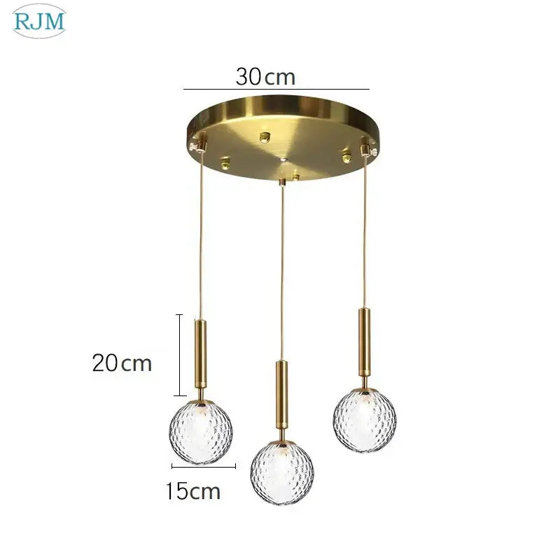 Modern brass and black glass ball led pendant light featuring gold-toned ceiling fixture with three textured glass globes
