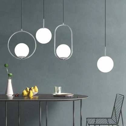 Modern brass and black glass ball pendant light with sleek chrome frames and frosted glass globes for dining room decorbites glass ball pendant