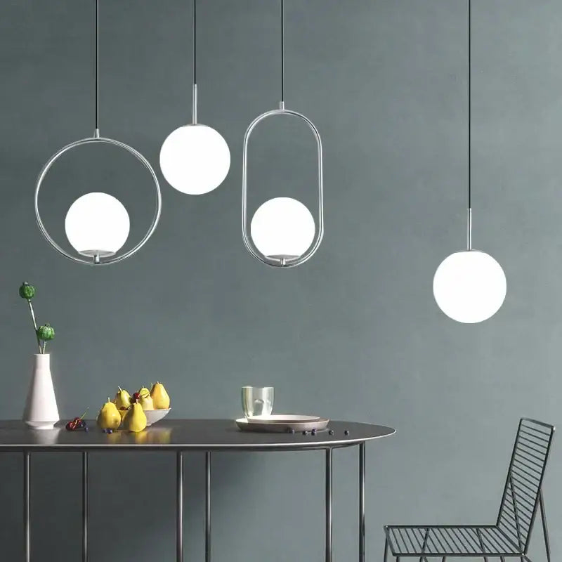 Modern brass and black glass ball pendant light with sleek chrome frames and frosted glass globes for dining room decorbites glass ball pendant